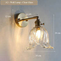 Modern adjustable glass and brass wall light for an elegant interior