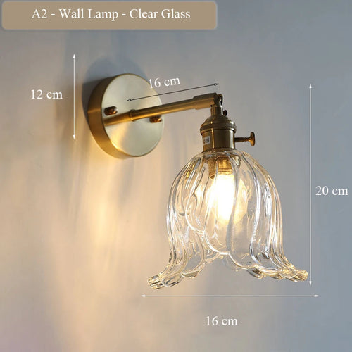 Modern adjustable glass and brass wall light for an elegant interior