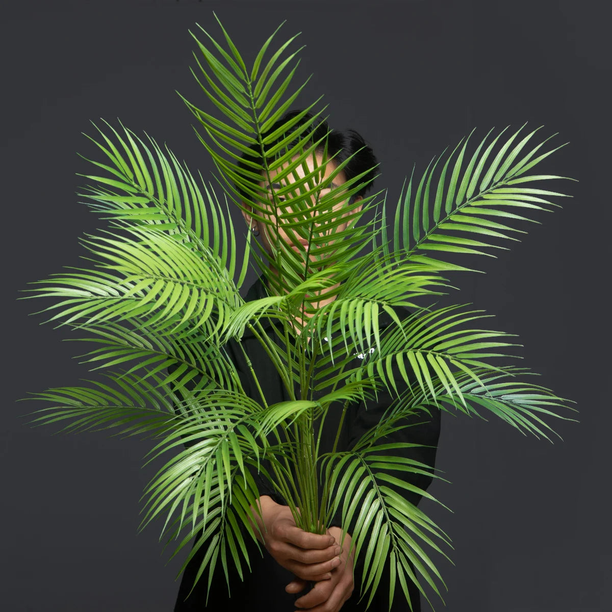 Large artificial palm tree with monstera leaves for outdoor decoration