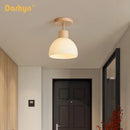 Simple wood chandelier with glass lampshade
