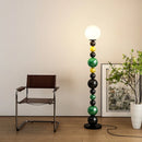 Modern floor lamp with colourful beads and glass shade