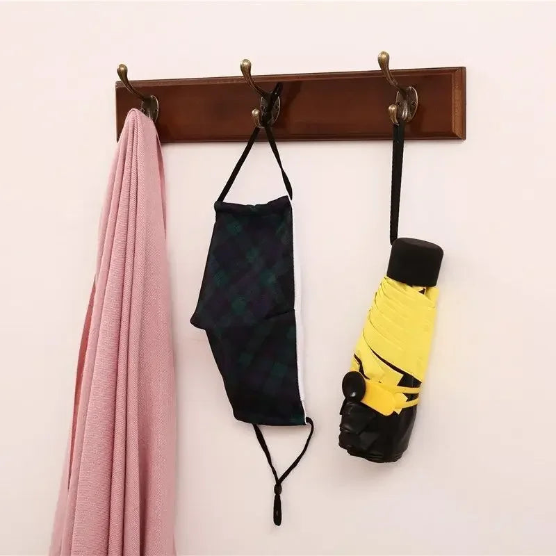 solid wood wall-mounted coat rack with decorative hooks and hangers