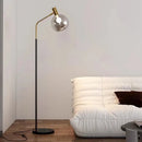 Elegant gold and black floor lamp in metal and glass