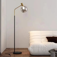 Elegant gold and black floor lamp in metal and glass