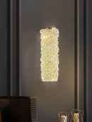 Gold metal wall light with clear crystal bulb and adjustable wire