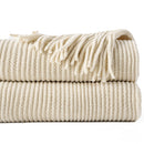Chenille knit throw with pompoms and checked pattern decor