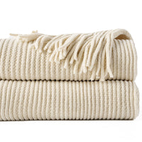 Chenille knit throw with pompoms and checked pattern decor