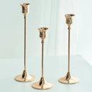 Set of three gold brass candle holders for weddings and dinners