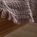 Lightweight cotton muslin throw with decorative tassels for living room