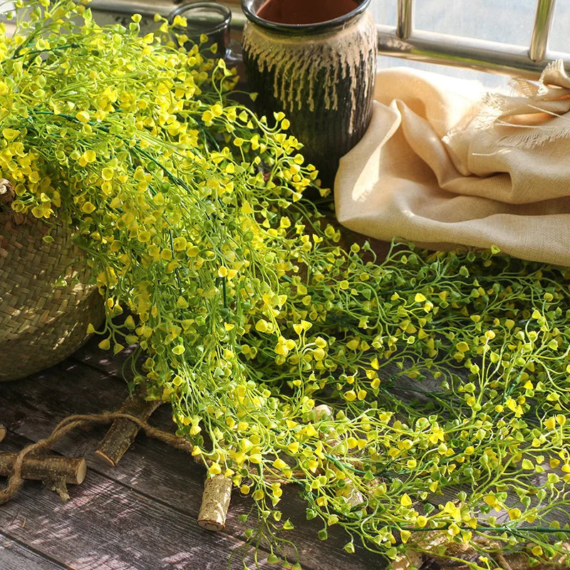 Rattan wall decoration with leaves and golden bell