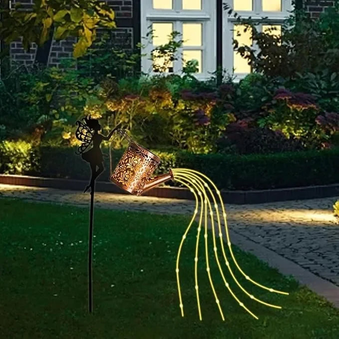 Fairy garden decoration with watering can and solar lanterns