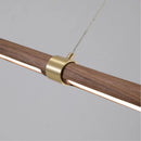 Minimalist wood and metal pendant light with adjustable height for versatile spaces
