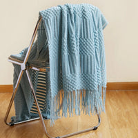 Lightweight knitted throw with pom-poms cosy style for sofa