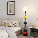 Modern floor lamp with colourful beads and glass shade