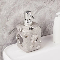 golden ceramic bottle with moon decor for lotion