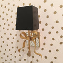 Bow shaped brass wall light for children's bedroom