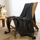 Waffle knit chunky throw with pom poms nordic style
