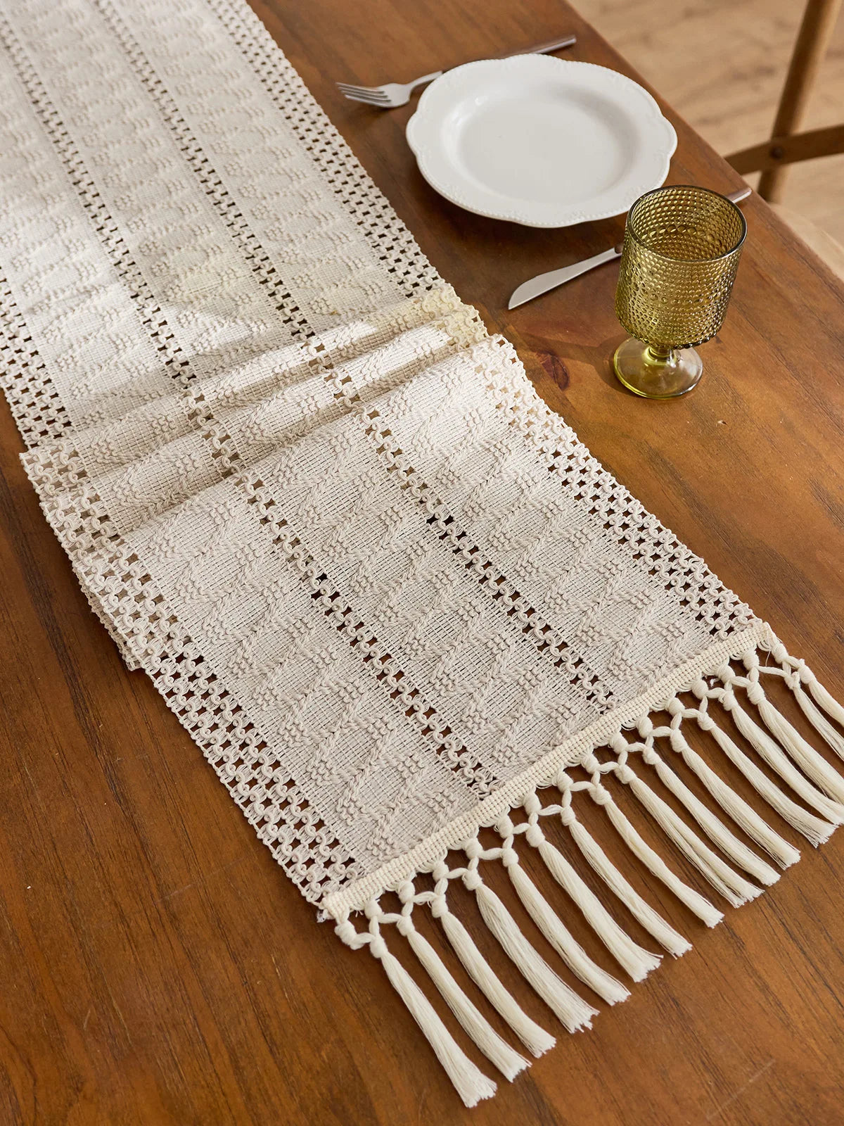 Beige boho woven table runner with tassels and geometric pattern