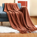 Nordic style knitted throw with pom poms for living room