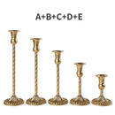 Set of three gold brass candle holders for weddings and dinners