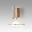 Wabi-sabi LED wall light in natural stone