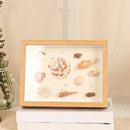 Handmade wooden photo frame with dried flowers and 3D plants