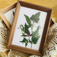 Handmade wooden photo frame with decorative leaf