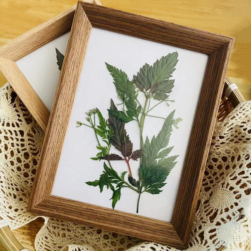 Handmade wooden photo frame with decorative leaf