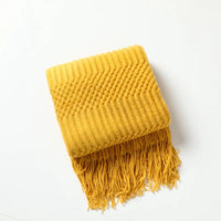 Lightweight acrylic knitted throw with pompons cosy style