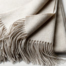 Soft wool throw with spiral pattern and fringes