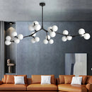 Glass chandelier with tree branches and glowing glass balls