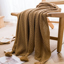 Chunky waffle knit throw with pom poms nordic style