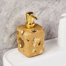 golden ceramic bottle with moon decor for lotion