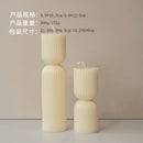 handcrafted scented candles with striped columns and wind chimes
