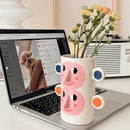 abstract ceramic vase with human face floral decoration