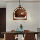 Modern glass and wood pendant light with adjustable height for indoor use