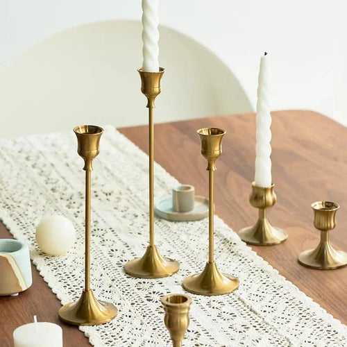 Set of three gold brass candle holders for weddings and dinners