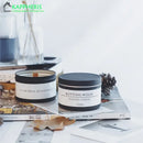 scented candles in tin cans with dried flowers