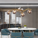 Iron chandelier with bird and suspended glass ball