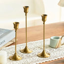 Set of three gold brass candle holders for weddings and dinners