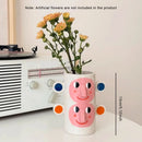 abstract ceramic vase with human face floral decoration