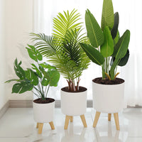 round flower pot on wooden stand for plants