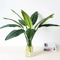 Tropical floral arrangement with decorative birds and bananas for weddings