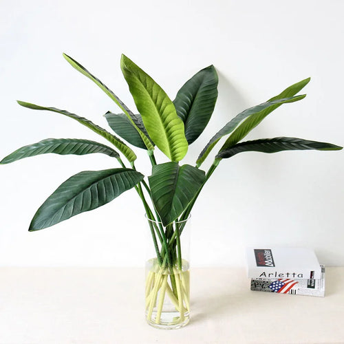Tropical floral arrangement with decorative birds and bananas for weddings
