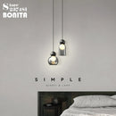 Transparent glass pendant light with decorative copper head