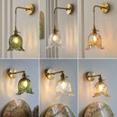 Modern adjustable glass and brass wall light for an elegant interior
