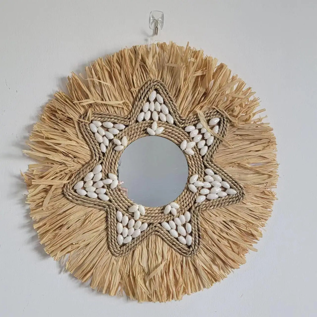 decorative mirror made of raffia and shells for wall decoration