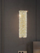 Gold metal wall light with clear crystal bulb and adjustable wire