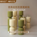 handcrafted scented candles with striped columns and wind chimes