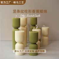 handcrafted scented candles with striped columns and wind chimes